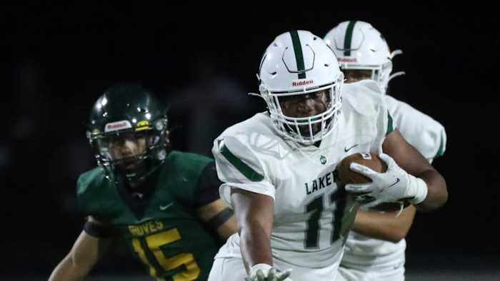 West Bloomfield tight end Brandon Davis-Swain runs the ball against Birmingham Groves during second-half action at Birmingham Groves on Thursday, Aug. 31, 2023